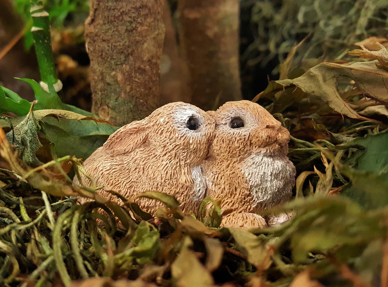 Woodland animal figurines and greenery for a baby shower table