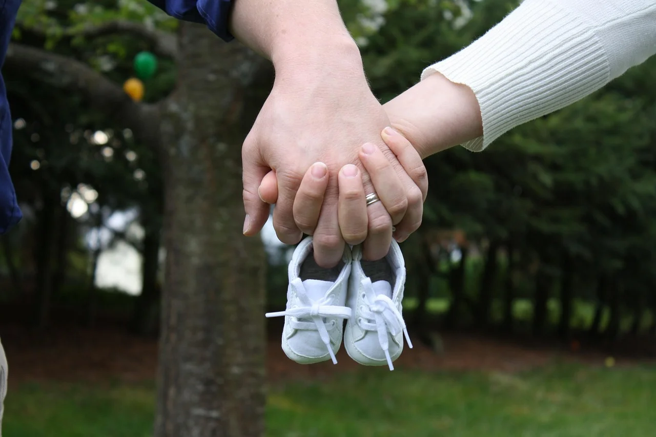 Pregnancy announcement ideas with baby shoes and an ultrasound